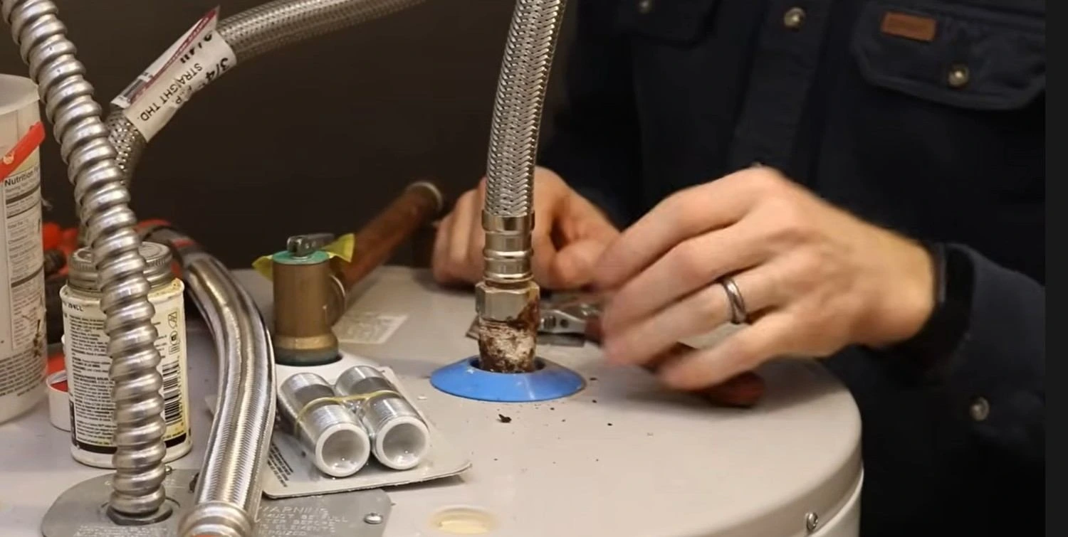 Plumber performing water heater repair service in Covington LA